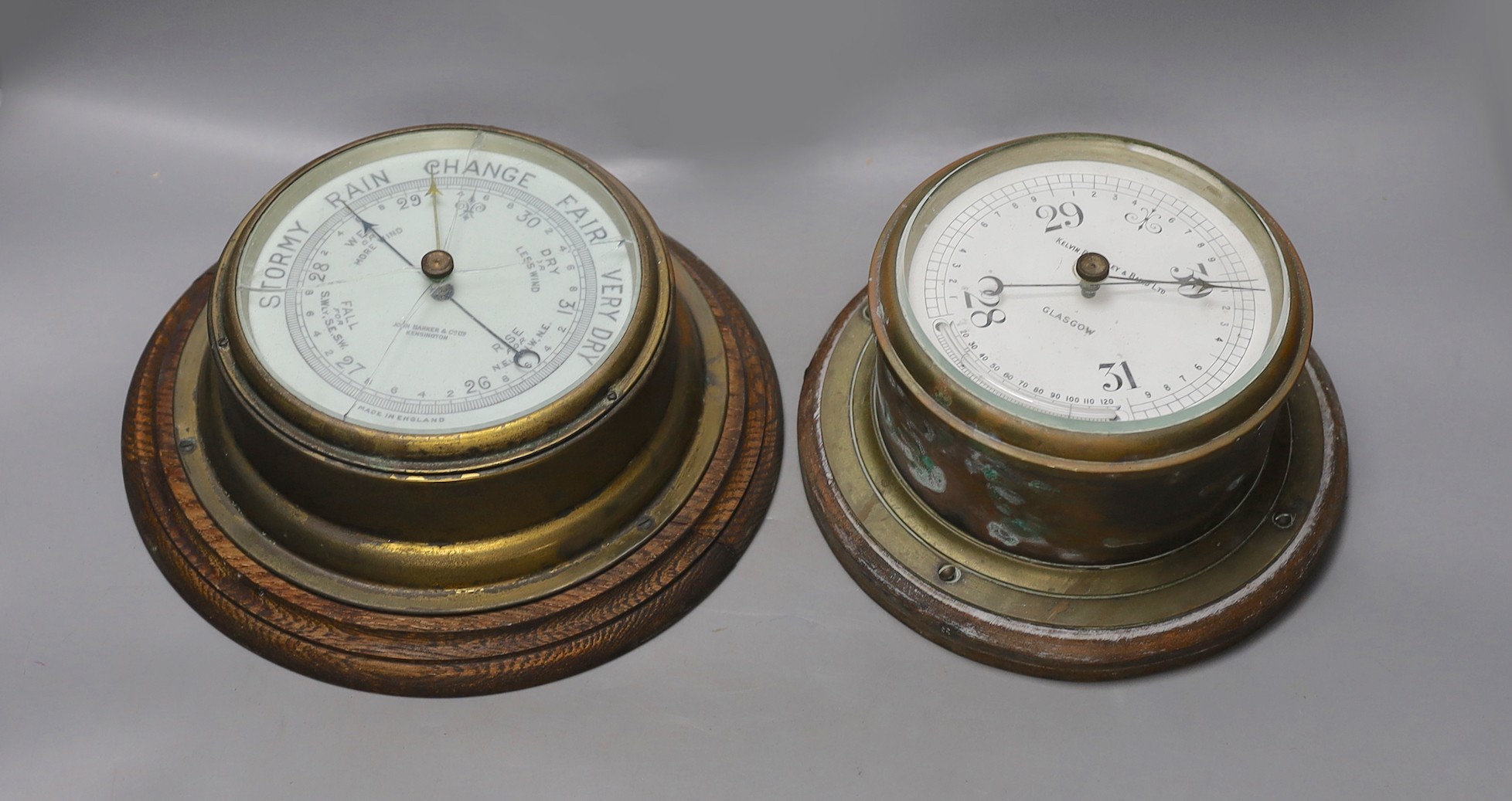 A John Barker & co brass bulkhead barometer and another by Kelvin Bottomly & Baird ltd., diameter 27. 5 cm